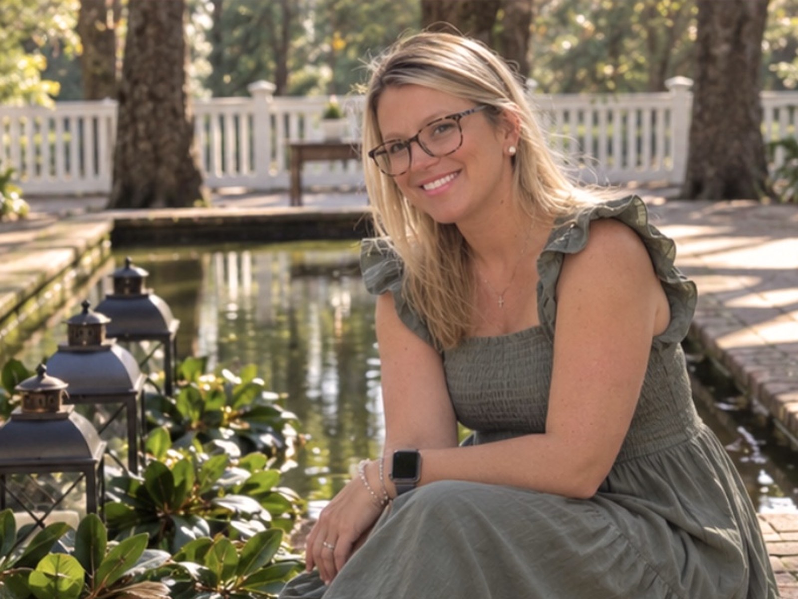 Ashley Smith Lucas, founder of Magnolia Grace & Co., seated beside a garden reflecting pool in Aiken, South Carolina.